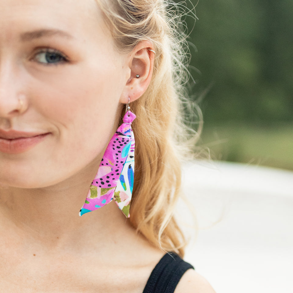 Silk tassel earrings featuring pink floral artwork by Jeanetta Gonzales