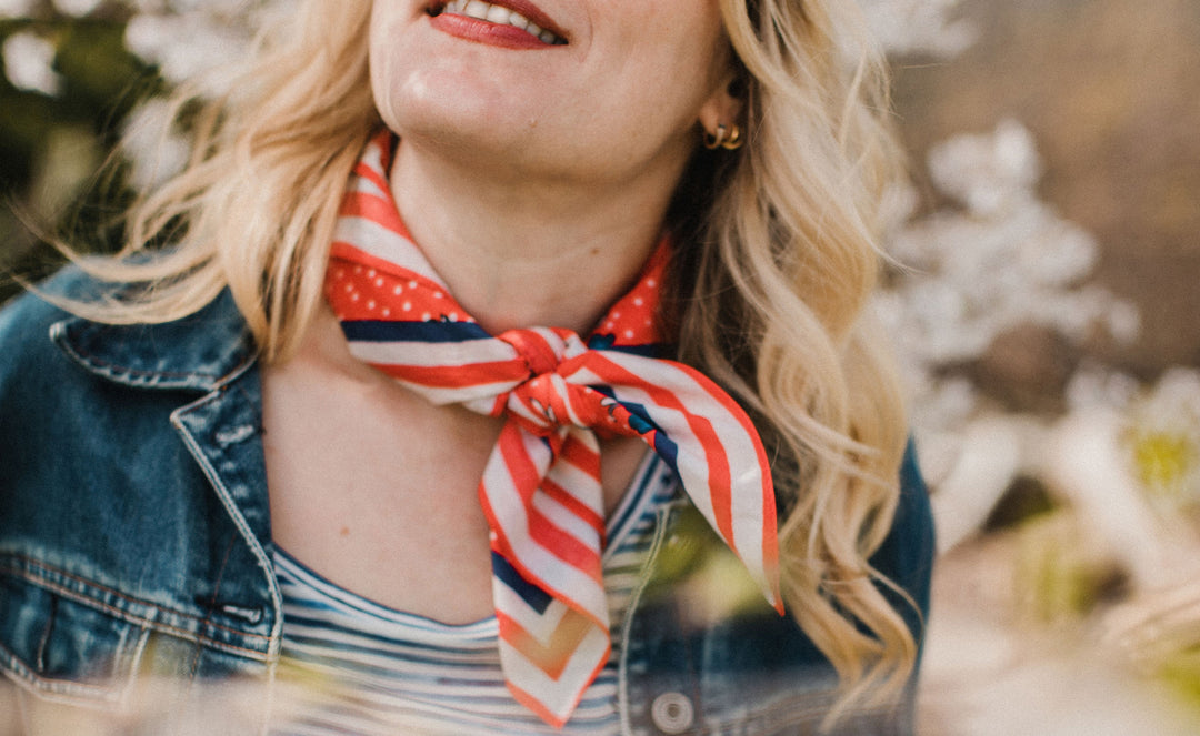 Woman wearing Molly Hatch red white and blue scarf bandana tied around her neck