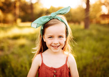 Load image into Gallery viewer, Girl wearing teal blue scarf bandana as a headband
