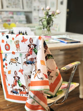 Load image into Gallery viewer, Fall Dogs scarf hanging from chair in artist&#39;s studio
