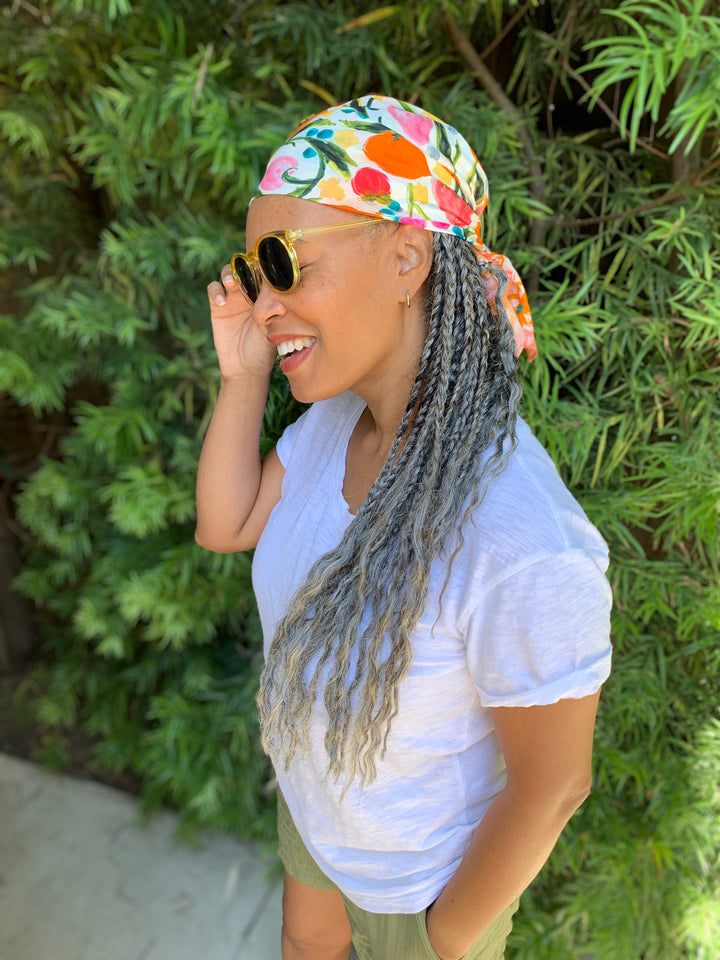 Model wearing Jeanetta Gonzales' tutti fruitti fruit themed scarf bandana as head wrap durag